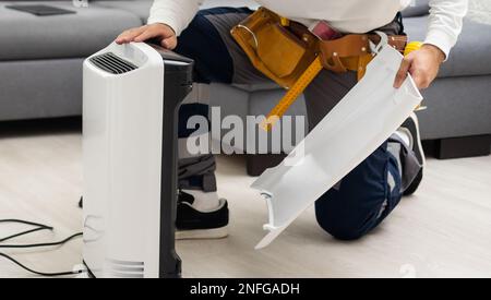 Air purifier service. Maintenance the air filter. Replace and clean the air filter. The filter have a lot of dust. Stock Photo