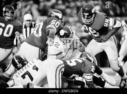 Jim Marshall (70), Minnesota Vikings defensive end, is congratulated in the  end zone by Bruce Bosley (77) of the San Francisco 49ers after he scooped  up a 49ers' fumble and ran 60