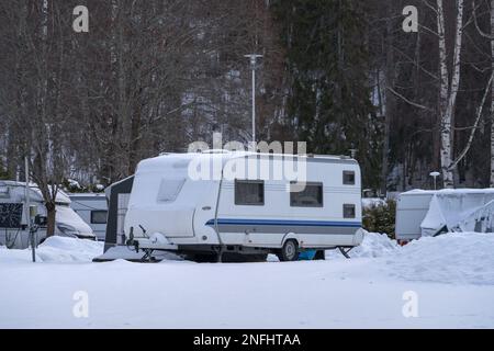 Winter camping, caravan trailer parked in Messilä Camping, Hollola, Finland Stock Photo