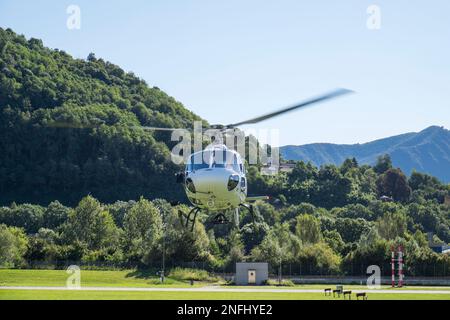 Switzerland, Agno-Lugano Airport, Helicopter on take off Stock Photo