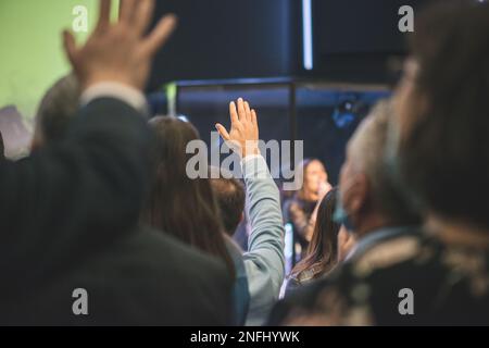 Hands in the air of people who praise God at church service Stock Photo