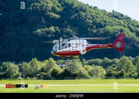 Switzerland, Agno-Lugano Airport, Helicopter on take off Stock Photo