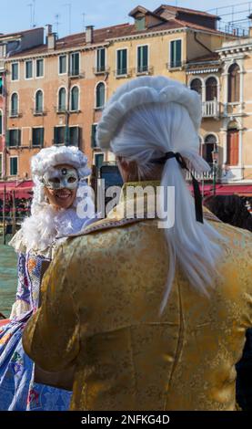 Carnival goer dressed in splendid costume and mask during Venice Carnival 2023 at Rialto, Venice, Italy in February Stock Photo