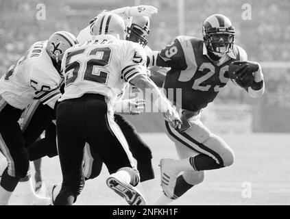 Los Angeles Rams' rookie running back Eric Dickerson (29) isn't going too  far on this run with Chicago Bears' tackle Jim Osborne (68) behind him and  Bears' linebacker Otis Wilson waiting up