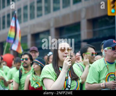 Toronto Ontario, Canada- June 26th, 2022: Employees of Td bank blowing a whistle while marching in Toronto's annual Pride Parade. Stock Photo