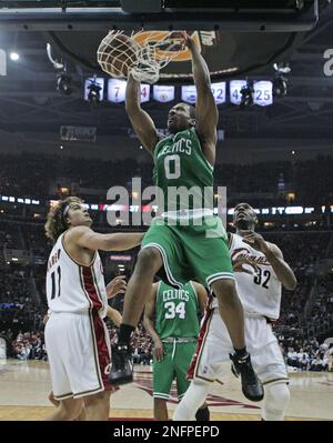 Boston Celtics' Leon Powe (0) dunks on Cleveland Cavaliers' Anderson Varejao,  from Brazil, left, and Joe Smith (32) during Game 3 of the NBA basketball  Eastern Conference semifinals Saturday, May 10, 2008, in Cleveland. (AP  Photo/Tony Dejak Stock