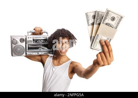 African american young man holding a boombox on shoulder and showing stacks of money isolated on white background Stock Photo