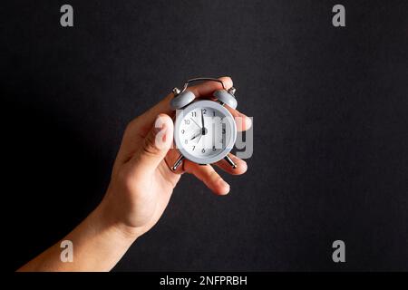 hand holding vintage little clock. Beautiful photo Stock Photo