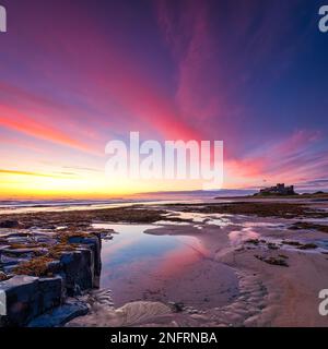 Bamburgh Castle at dawn from the beach in mid-summer, Bamburgh, Northumberland, England, United Kingdom Stock Photo