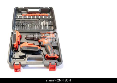 Tool case with electric drill of batteries without cables and different bits and screwdrivers, photo copyspace. Stock Photo