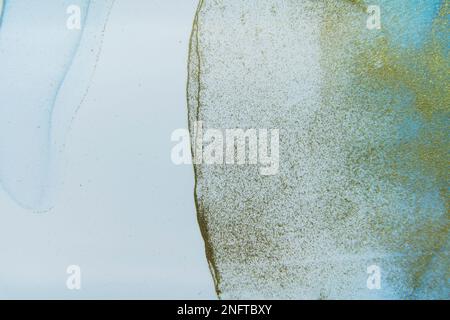 Rich bright abstract picture. Luxury abstract fluid art painting alcohol ink. Background blue ice gold sparkles. Stock Photo