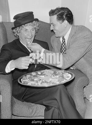 Harpo Marx was guest of honor at a party at the Hampshire house on May 20,  1949 in New York. Some of the other guests were all stressed up, but Harpo  wore