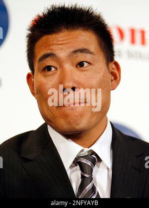 Japanese free agent outfielder Kosuke Fukudome, left, shows his new team  jersey with the Chicago Cubs manager Jim Hendry at Wrigley Field,  Wednesday, Dec. 19, 2007, in Chicago. (AP Photo/Nam Y. Huh