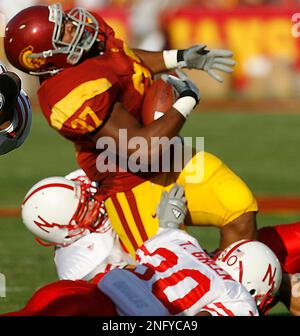 https://l450v.alamy.com/450v/2nfyca9/southern-californias-ryan-powdrell-falls-awkwardly-as-he-is-tackled-by-nebraskas-tierre-green-bottom-and-adam-carriker-hidden-in-the-fist-quarter-of-a-college-football-game-saturday-sept-16-2006-in-los-angeles-after-the-play-powdrell-was-taken-off-the-field-with-a-leg-injury-ap-photodanny-moloshok-2nfyca9.jpg