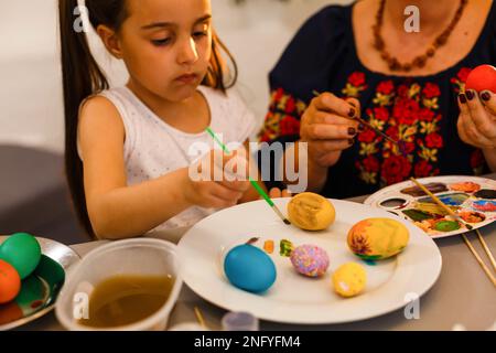 colouring eggs for eastertime at home Stock Photo