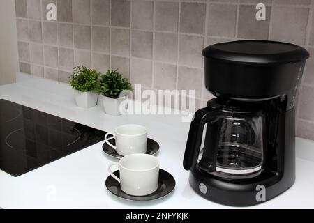 https://l450v.alamy.com/450v/2nfykjk/freshly-prepared-coffee-in-a-filter-coffee-machine-served-in-white-cups-that-is-rich-in-antioxidants-fights-alzheimers-and-parkinsons-2nfykjk.jpg