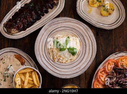 Close-up of asorted dished, cutlet salad ribs fries  Stock Photo