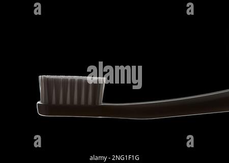 Close up of white toothbrush isolated on black background Stock Photo