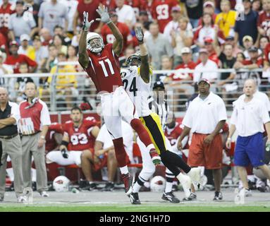 Arizona Cardinals Larry Fitzgerald jumps to catch the football for a  37-yard gain in front of St. Louis Rams Aeneas Williams (35) and Jerametius  Butler (23) for the first play of the