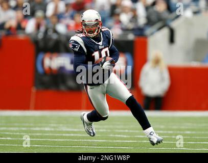 Washington Redskins wide receiver Donte' Stallworth (19) is tackled by New  England Patriots cornerback Devin McCourty (32), rear, Julian Edelman (11)  during the first half at FedEx Field in Landover, MD, Sunday