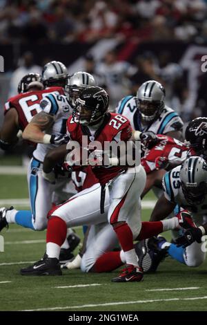 Atlanta Falcons running back Warrick Dunn (28) gets past Cleveland Browns  end Alvin McKinley (97) for