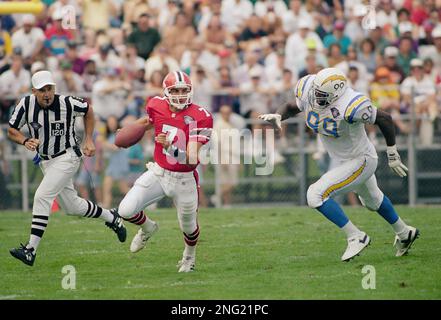 Atlanta Falcons quarterback Perry Klein (7) scrambles away from San Diego  Chargers lineman Raylee Johnson (99) in the Hall of Fame game July 30, 1994  n Canton, Ohio. (AP Photo/Bruce Zake Stock Photo - Alamy