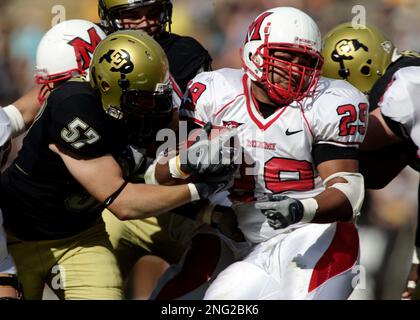 Miami Ohio running back Austin Sykes (29) is brought down by Akron  defensive back Davanzo Tate (5) in the first quarter during their football  game Wednesday, Nov. 14, 2007, in Oxford, Ohio. (