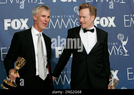 Head writer Mike Sweeney, left, and Conan O'Brien hold their