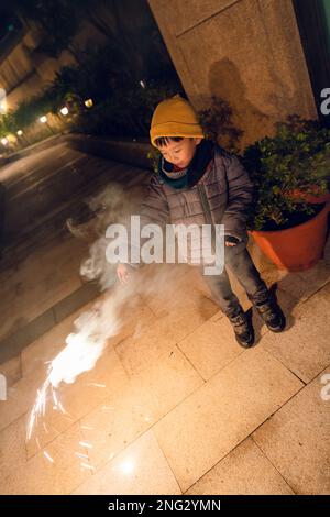 A young boy plays sparklers for the first time Stock Photo