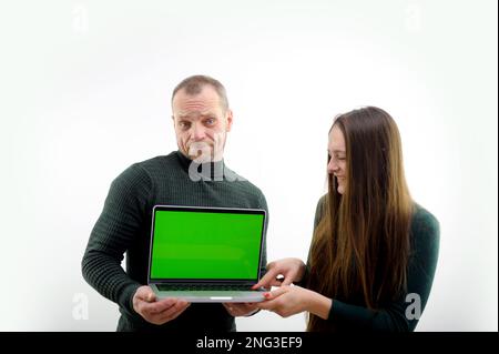 Two software developers analyzing source code looking at green screen chroma key mockup with coworker sitting at desk writing algorithm. Software developers working on artificial intelligence project Stock Photo