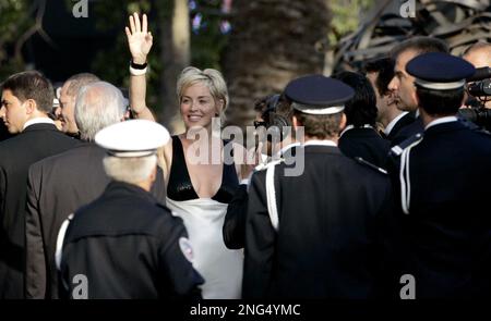 American actress Sharon Stone waves while she plays baseball