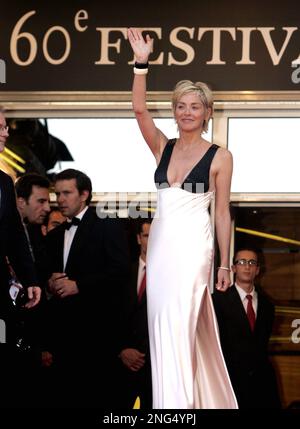 American actress Sharon Stone waves while she plays baseball