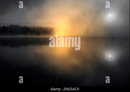 Lake Cassidy sunrise in fog with reflections and peaceful lake, Stock Photo