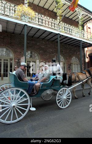 Tourists enjoy a horse and buggy ride through the French Quarter where the National Trust for Historic Preservation recognized the city for exemplary achievement in heritage tourism, in New Orleans, Wednesday, March 7, 2007. (AP Photo/Cheryl Gerber)