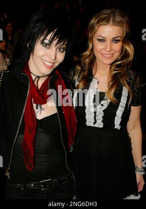 Joan Jett, left, and Carmen Electra pose for photographers before the ...