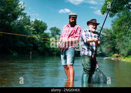 Big game fishing. fisher hold fish net. hobby. man checkered shirt on  ranch. fisherman with fishing rod. man in cowboy hat. western portrait.  Vintage style man. Wild West retro cowboy. fly fishing