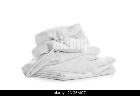 Pile of towels and bedding on white background Stock Photo