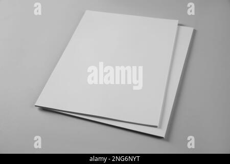 Blank brochures on grey background. Mockup for design Stock Photo