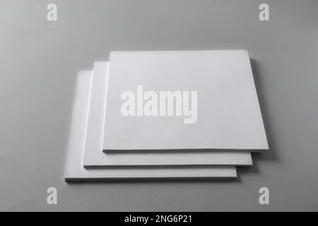 Stack of blank paper sheets for brochure on light grey background Stock Photo