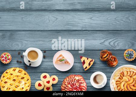 Flat lay composition with different delicious pies on blue wooden table. Space for text Stock Photo