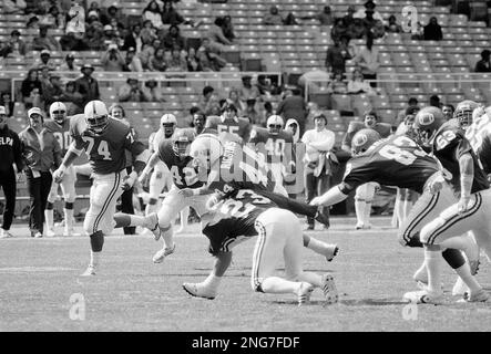 Washington Redskins' full back John Riggins (44) is slowed down