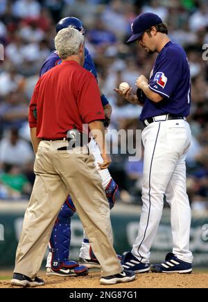 Los Angeles Angels' Garret Anderson, left, is greeted at home by teammate  Vladimir Guerrero after he hit a three-run homer off Texas Rangers pitcher  Adam Eaton in the first inning of a