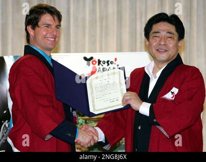 Hollywood superstar Tom Cruise, left, is presented with a