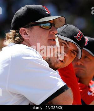 Tampa Bay Rays pitchers Josh Fleming, left to right, Zach Eflin and Shane  McClanahan laugh in the dugout after watching infielder Luke Raley pitch  during a baseball game against the Toronto Blue