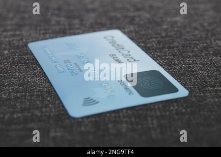 Credit card with fingerprint sensor in blur style. Close up of biometric credit card lying on the flooring. Using safe and simple way to pay online fo Stock Photo