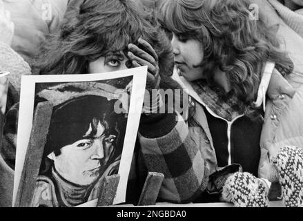 Woman mourns the death of former Beatles member, guitarist John