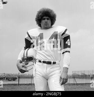 New York Jets John Riggins goes through the motions of a fake handoff  during training session at Rikers Island in New York City, Sept. 26, 1973.  He arrived for training sporting a