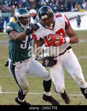 Atlanta Falcons' Alge Crumpler (83) scores on a 18 yard touchdown pass from  quarterback Michael Vick as the Los Angeles Rams' Adam Archuleta (31)  defends in the first quarter of their NFC