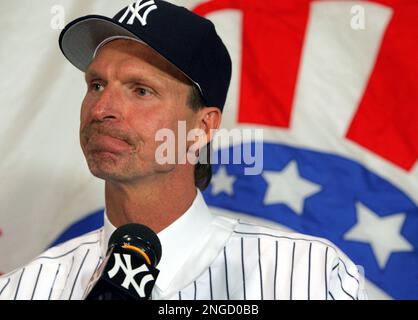 New York Yankees pitchers Randy Johnson, front and Carl Pavano, background,  raise their legs as they stretch at the start of workouts at spring  training, Tuesday, Feb. 22, 2005, in Tampa, Fla. (