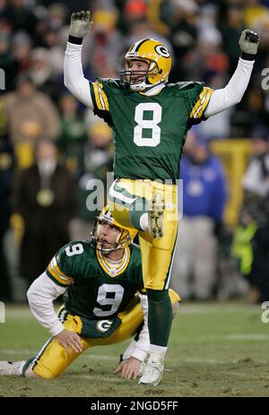 Green Bay Packers holder B.J. Sander watches as kicker Ryan